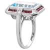 DIAMOND AND RUBY SET WITH A 14X8MM SKY BLUE TOPAZ CENTER ON WHITE GOLD RING