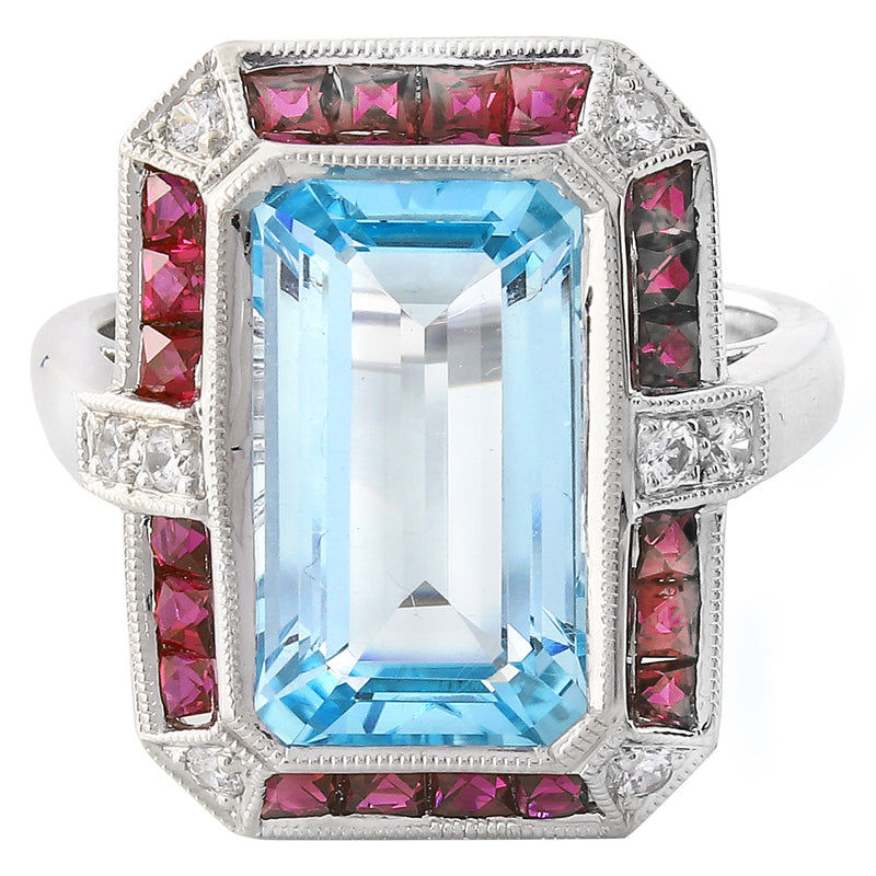 DIAMOND AND RUBY SET WITH A 14X8MM SKY BLUE TOPAZ CENTER ON WHITE GOLD RING