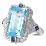 DIAMOND AND SAPPHIRE SET WITH A 14X8 MM SKY BLUE TOPAZ CENTER ON WHITE GOLD RING