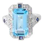 DIAMOND AND SAPPHIRE SET WITH A 14X8 MM SKY BLUE TOPAZ CENTER ON WHITE GOLD RING