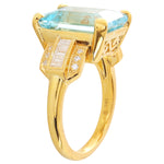 Sky blue topaz 14x10mm emerald cut center with diamond yellow gold ring