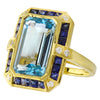 DIAMOND AND SAPPHIRE SET WITH A 14X8MM SKY BLUE TOPAZ CENTER ON YELLOW GOLD RING