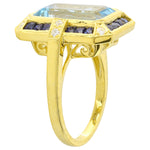 DIAMOND AND SAPPHIRE SET WITH A 14X8MM SKY BLUE TOPAZ CENTER ON YELLOW GOLD RING