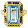 DIAMOND AND SAPPHIRE SET WITH A 14X8MM SKY BLUE TOPAZ CENTER ON YELLOW GOLD RING