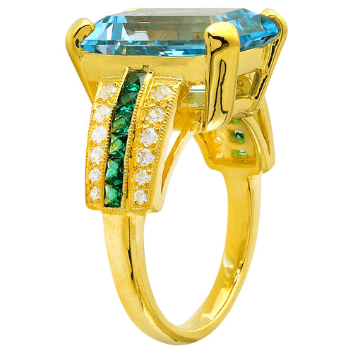 DIAMOND AND TSAVORITE SET WITH A 14X10 MM SKY BLUE TOPAZ CENTER ON YELLOW GOLD RING